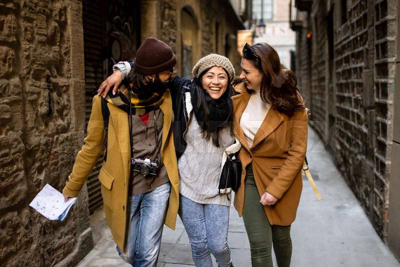 Cheerful multi-ethinc group of friends tourists having fun and walking on the streets of Barcelona - Travel, holidays and friendship concept