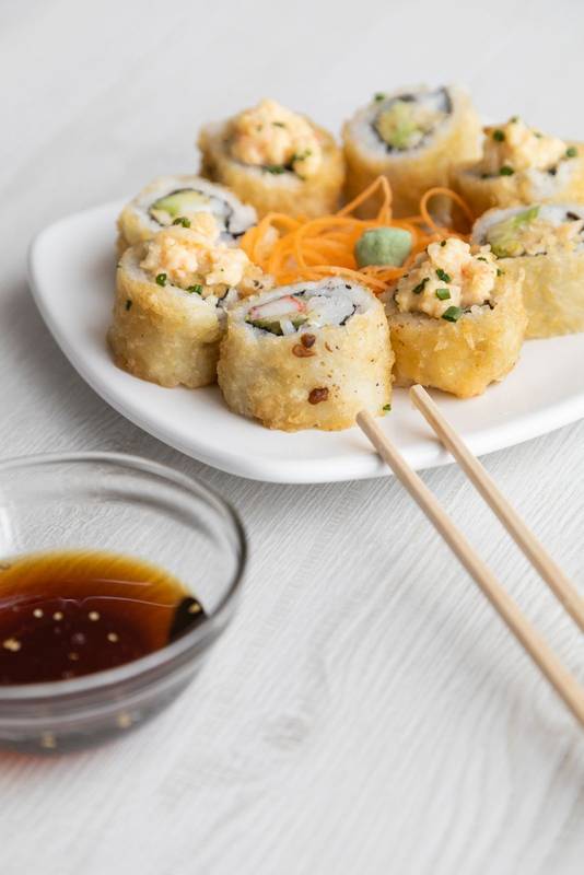 chopsticks and container with soy sauce ready to be served, healthy food in studio,sea food