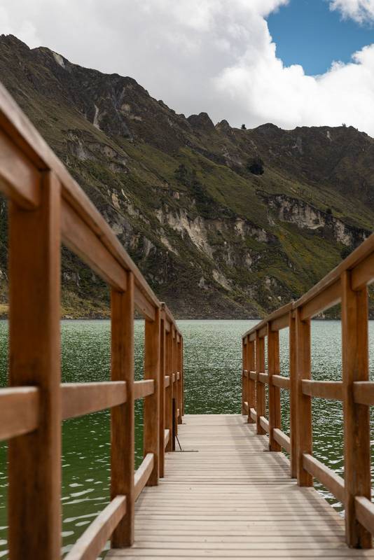 rustic wooden bridge stretches over the water, landscape