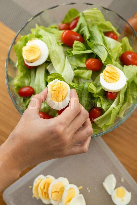 fresh and elegant salad featuring tomato, lettuce, and a hard-boiled egg, salad ingredients