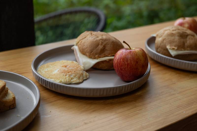 balanced breakfast with a sandwich, egg tortilla, and red apple