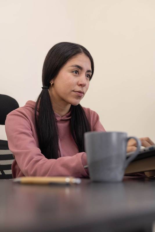 woman feeling tired and unmotivated during a long workday in a modern workspace.