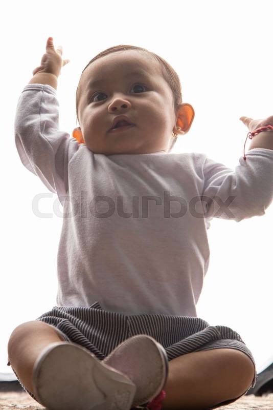 little latin girl with raised hands j having fun