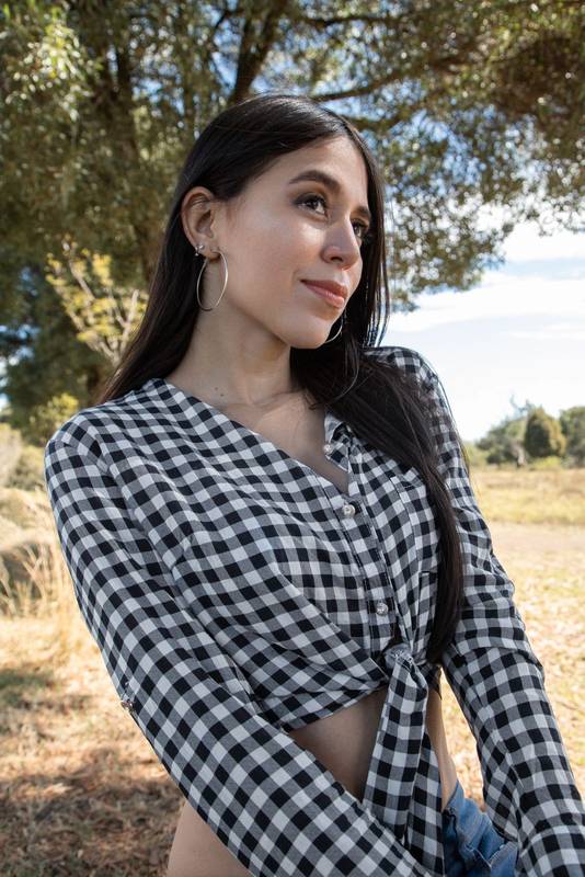 face of a beautiful woman smiling with long black hair