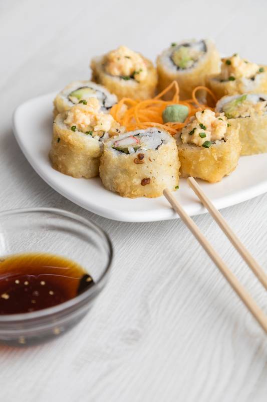 chopsticks and container with soy sauce ready to be served, healthy food in studio,sea food