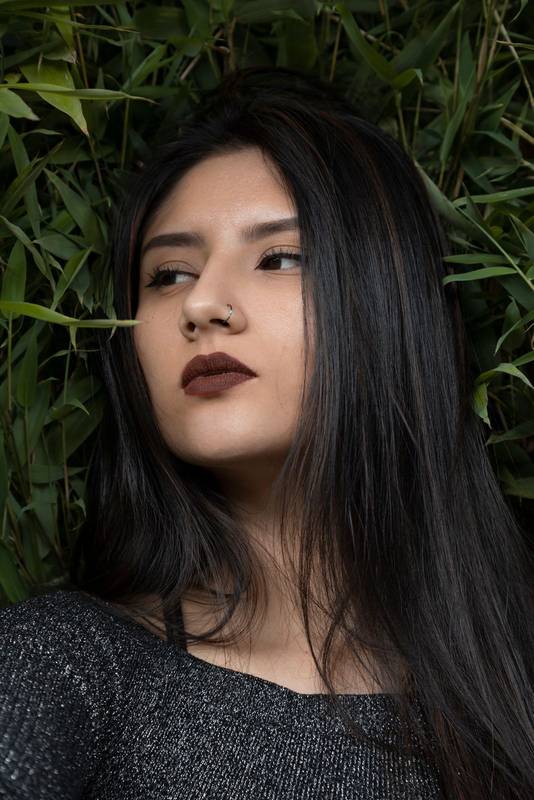 latin woman background several leaves of a plants, studio and nature