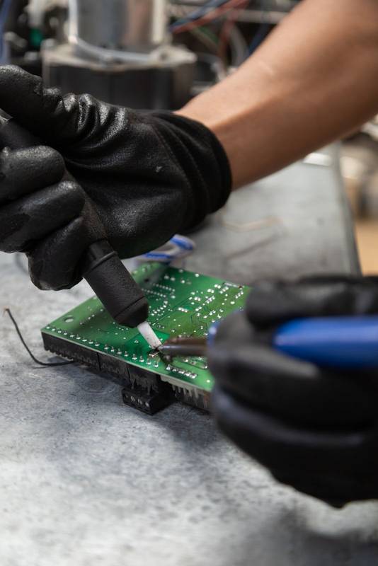 chnology and equipment restoration inholding a welding machine to repair a chip, te workshop