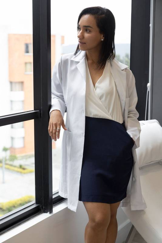 young female doctor on a sunny day, wearing a white coat