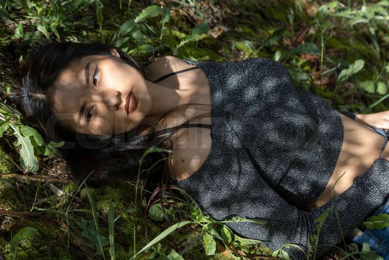lying down resting on various plants and under the shade of trees on a sunny day