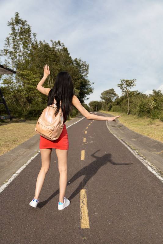slim woman walking on asphalt road, having fun on sunny day, lifestyle