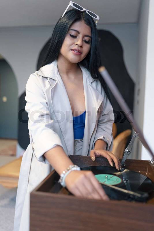 preparing a party, playing music inside the home a young woman