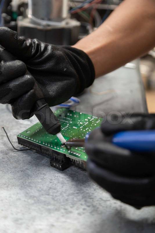 chnology and equipment restoration inholding a welding machine to repair a chip, te workshop