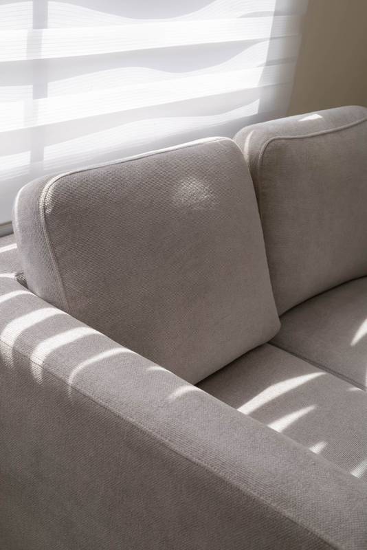 Comfortable white sofa with two seats in a cozy living room, decorated