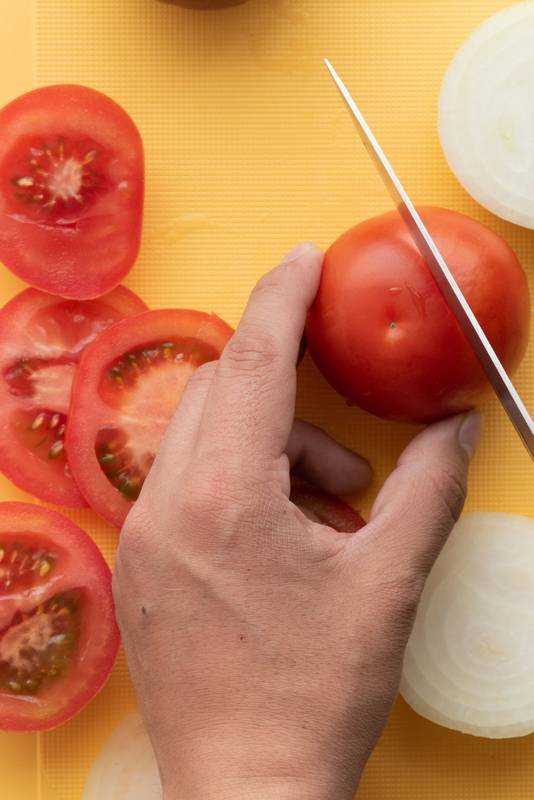sharp knife slicing a tomato,  healthy food
