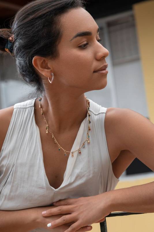 face in profile, leaning against a balcony, fashionable, female model
