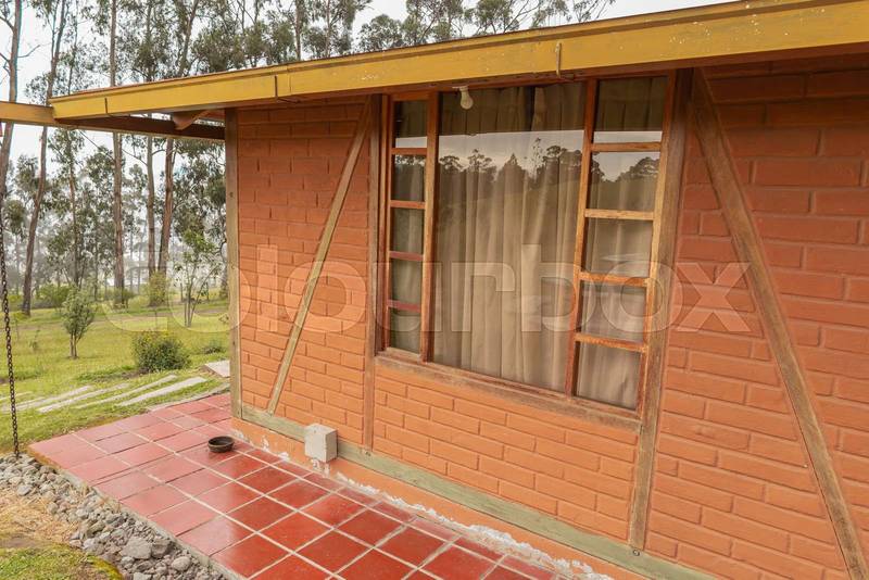 small brick house with wide window, cozy rustic home, lifestyle