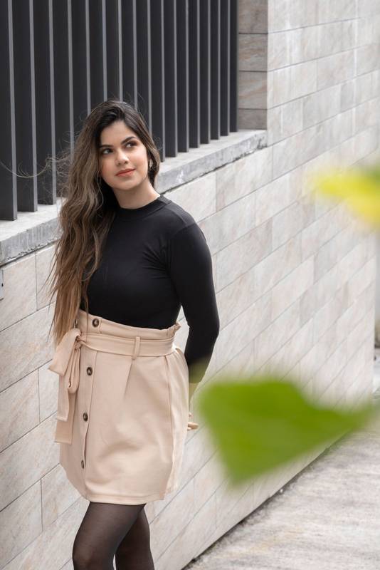 attractive slim young latin woman standing with her hands on her hips