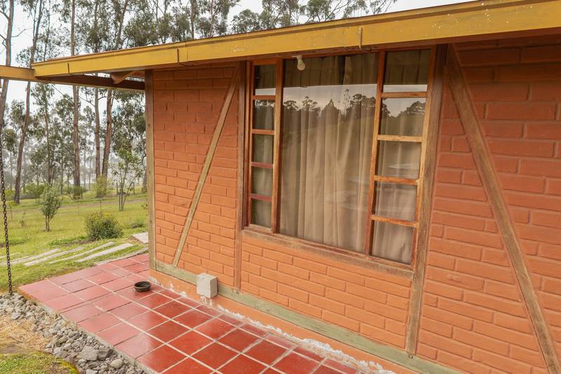 small brick house with wide window, cozy rustic home, lifestyle