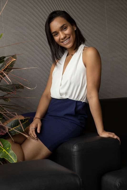 studio and beauty sitting on a sofa a beautiful young latin woman