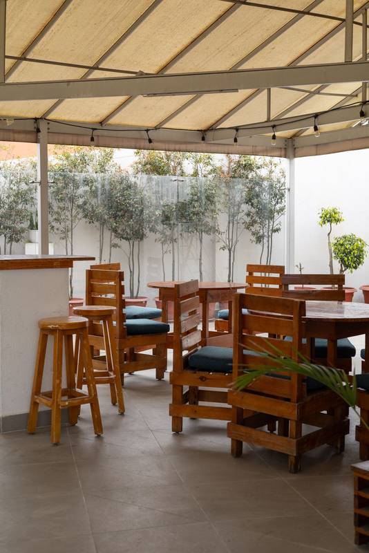 featuring sturdy wooden chairs, ideal for relaxing meals in a natural and inviting atmosphere, restaurant