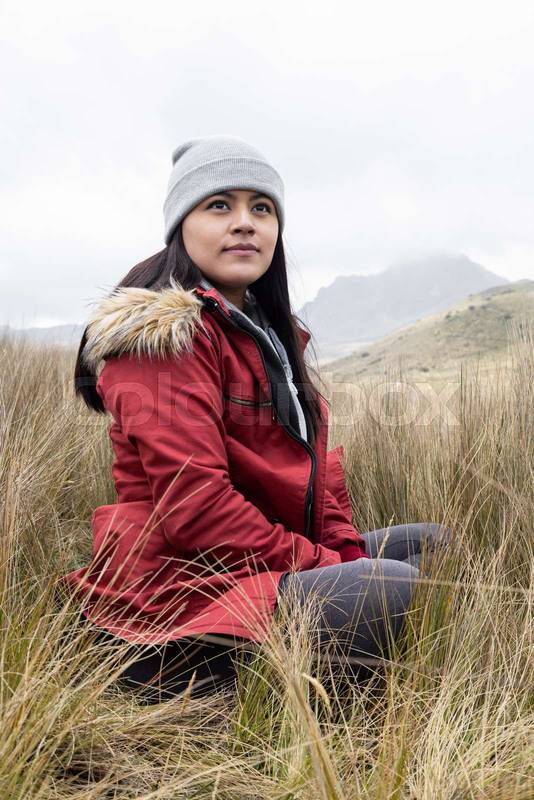 sitting in a meadow a latin young woman , relax time on nature