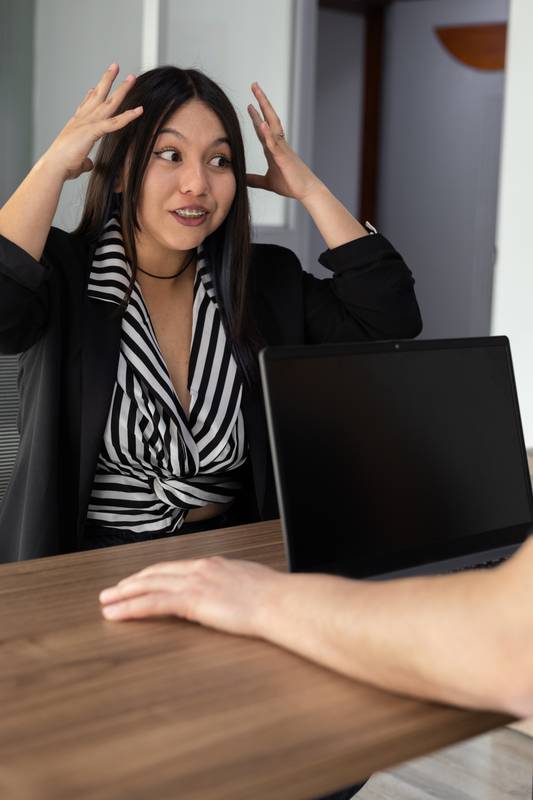 woman with her hands framing her forehead, expressing anticipation and focus. The image conveys introspection and mental exploration, angry