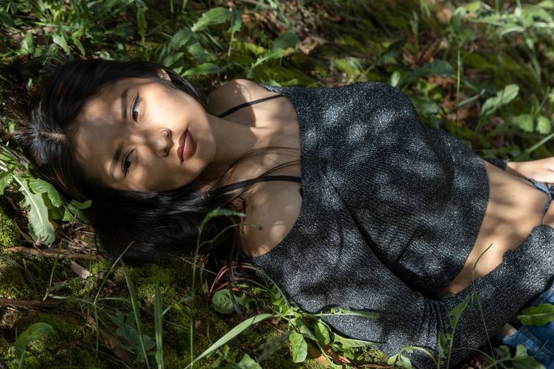 lying down resting on various plants and under the shade of trees on a sunny day