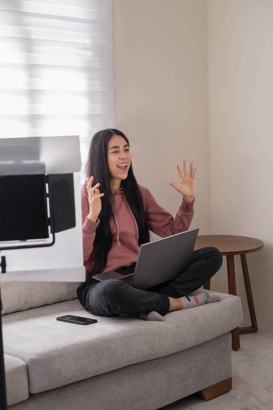 She appears immersed in a lively remote conversation
