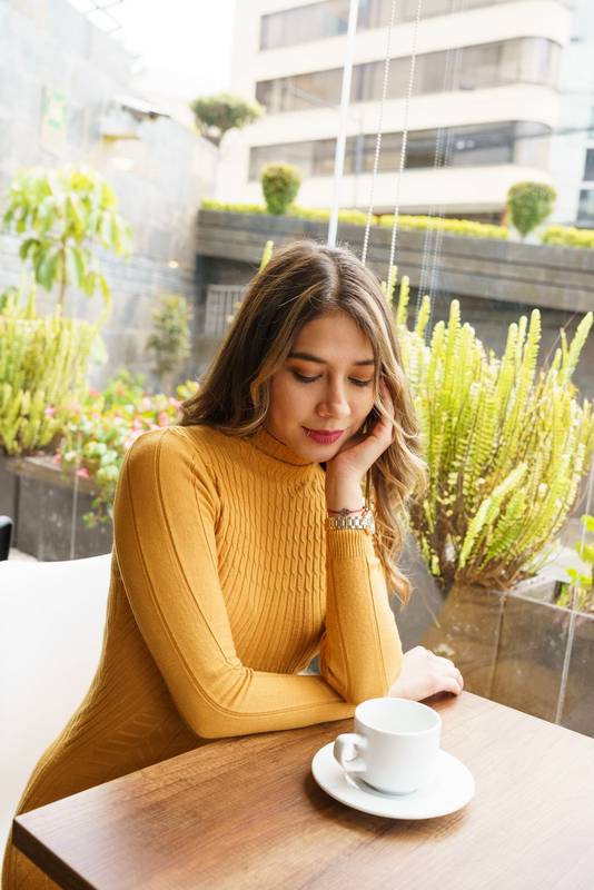 morning resting sitting at a table a beautiful, young, latin woman