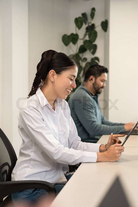 colleagues review slides together, perfecting their pitch deck before a key investor meeting.