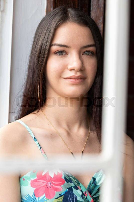 Distracted slim young woman with long straight hair, details of her face, lips