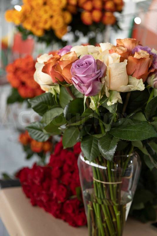 bouquet of natural colorful roses in a glass vase