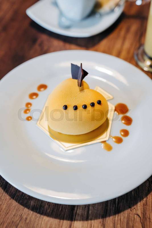 heart-shaped cake with yellow icing, gourmet decoration, food