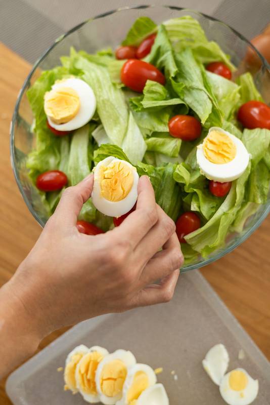 fresh and elegant salad featuring tomato, lettuce, and a hard-boiled egg, salad ingredients