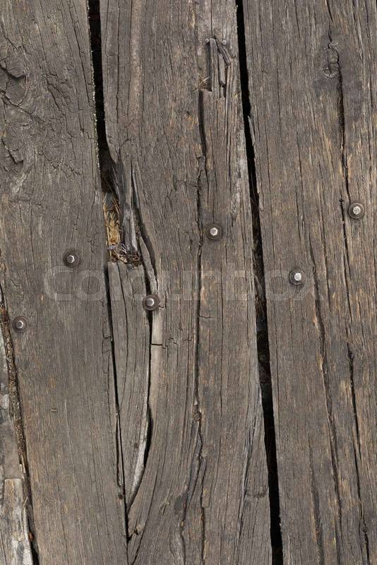 wooden plank placed as a small rustic bridge on the ground