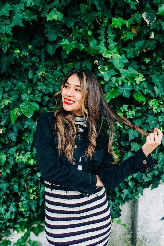 playing with blond, long wavy hair a young latin woman